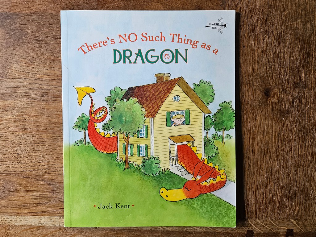 Front cover showing a red dragon curled around a yellow house, with a boy peeking from the window.