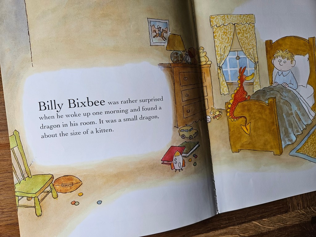 Illustration of Billy in bed, looking surprised at a small red dragon sitting at the foot of his bed.